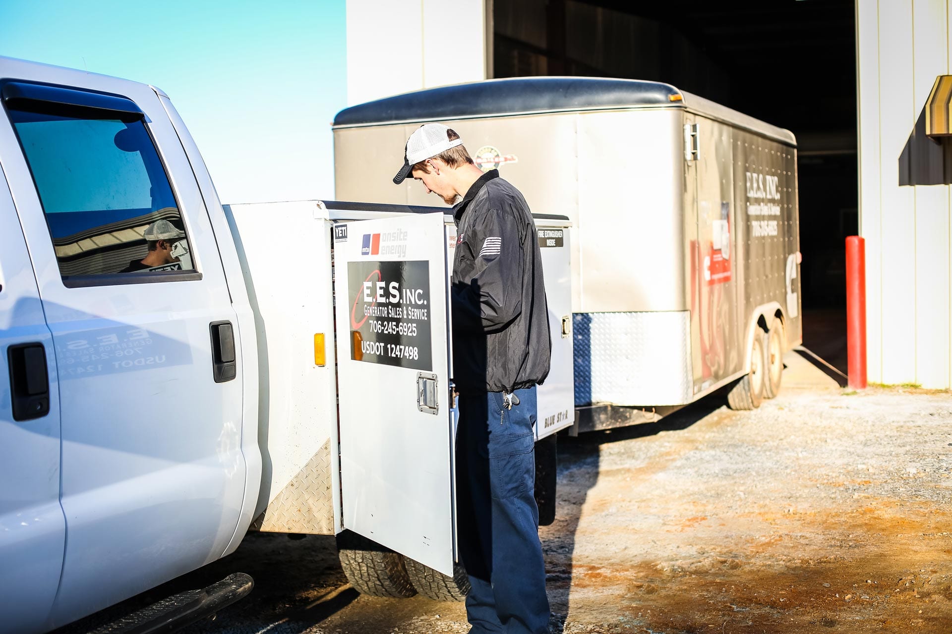 new-picture-guy-beside-truck-and-trailer E.E.S. Inc. | employee outside beside a company truck and trailer